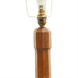 Mouseman - oak standard lamp, the turned octagonal column terminating to a stepped cavetto octagonal base, with carved mouse signature, by the workshop of Robert Thompson of Kilburn
