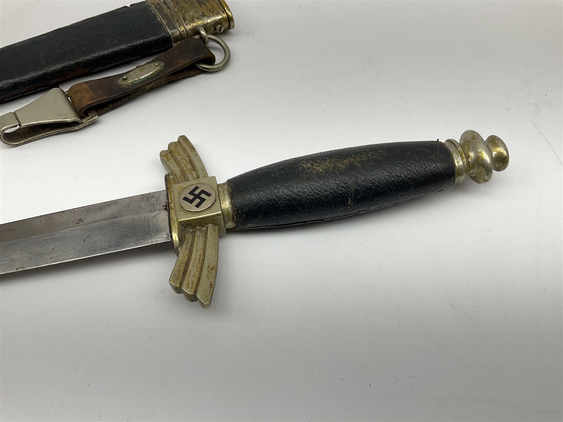  WW2 German SMF Solingen DLV flyers dagger with 16cm steel blade, nickel downswept cross-piece and pommel and leather covered grip, in leather and nickel scabbard with leather suspension strap L34cm overall. After WWI Germany was forbidden an air force by the Treaty of Versailles however the Deutscher Luftsport-Verband (German Air-sport Association) was formed in March 1933 from various sports flying clubs and had branches for aeroplane, gliding and balloon flying. Under cover of the sporting DLV, many future Luftwaffe pilots trained to fly. DLV was embodied with the NSKK in March 1935 and 1st March 1937 Luftwaffe formed.
