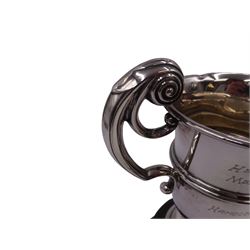 1920s silver trophy cup, with twin scroll handles and girdle, upon circular stepped foot,  the body with presentation engraving 'The Helen Andrews Memorial Cup, Handicraft Section', hallmarked Walker & Hall 1927, fixed upon ebonised wooden base with applied winners plaques, including base H18cm