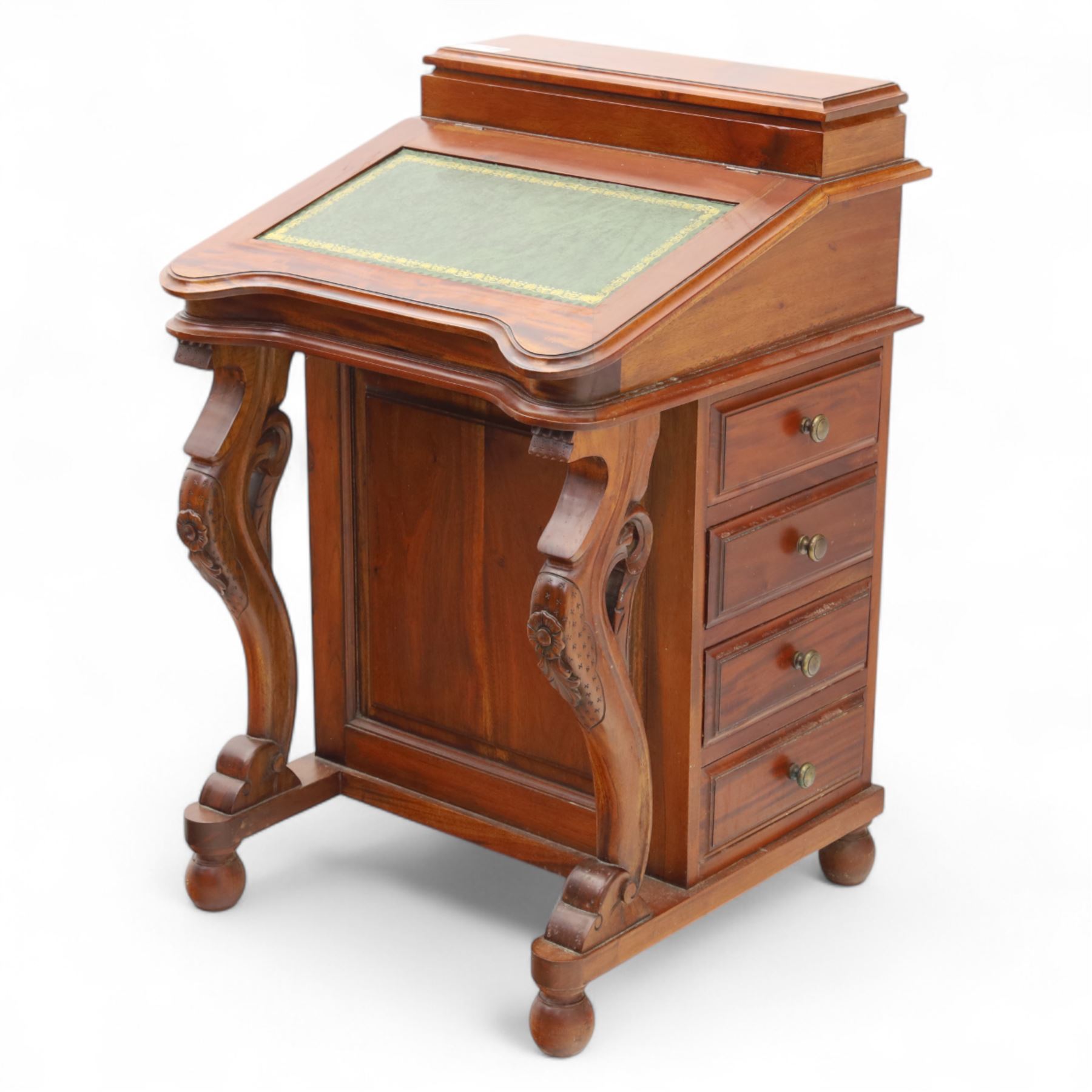 Victorian design mahogany Davenport desk, the sloped writing surface inset with tooled green leather and hinged to reveal a fitted interior, with a pen compartment to the raised gallery back, four drawers to each side, on carved scrolled supports with acanthus detail, raised on turned feet