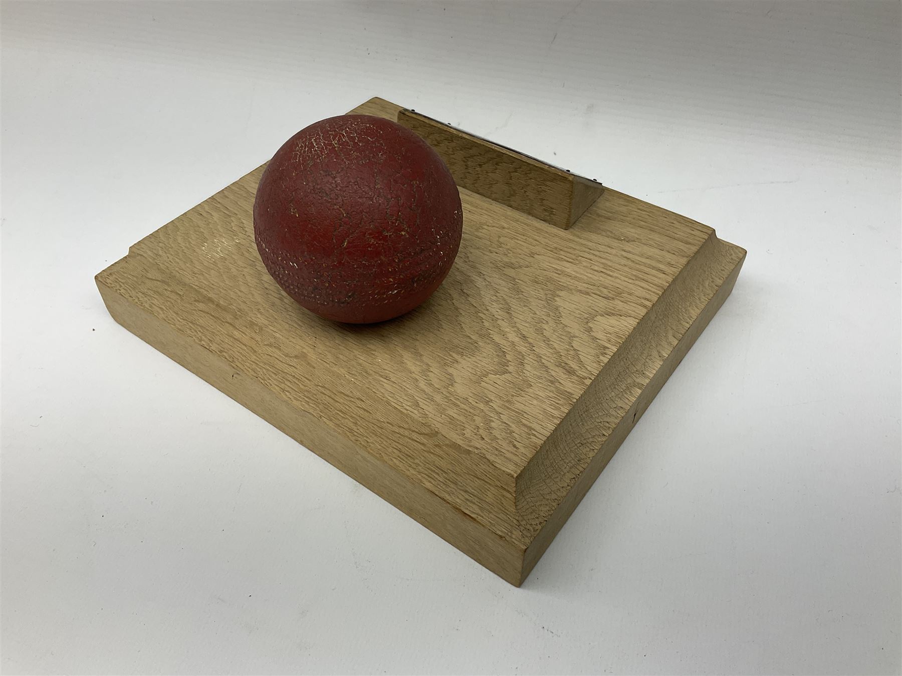 Raich Carter - early school cricket trophy of a cricket ball mounted on an oak base with white metal plaque inscribed 'Swan Cup Final/July 1927/Hendon v Jas.Wms.St/Scores/Hendon 189 for 2 wickets/Jas.Wms.St 55/Carter 111 runs (not out) Four wickets for 21 runs/Hendon School Souvenir/from his Head master G.F. Park' L20cm. Provenance: By direct descent from the family of Raich Carter having been consigned by his daughter Jane Carter.