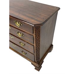 George III Chippendale design mahogany chest, moulded rectangular top with canted corners, wide canted uprights with blind fretwork decoration, two short and three long with moulded fronts, shaped brass handle plates, on ogee bracket feet 