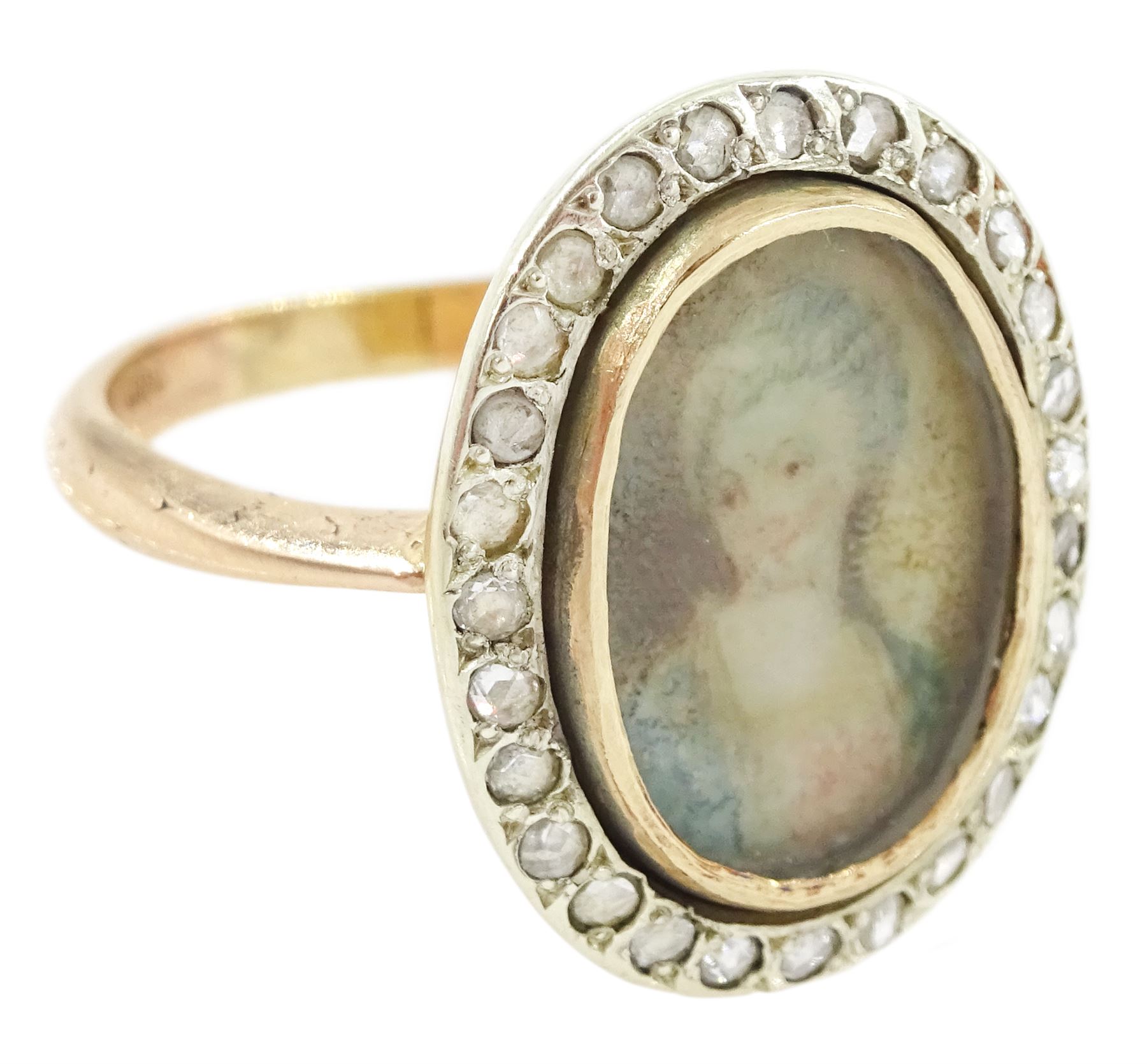19th century 9ct gold diamond portrait ring, set with an oval miniature of a woman in 18th century dress on ivory, under a glazed panel, with rose cut diamond surround, on later shank. This lot has been registered for sale under Section 10 of the APHA Ivory Act