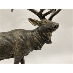 Bronzed cast metal figure of a stag upon a naturalistic base, raised on a wooden plinth, H47cm