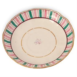 Late 19th century tea service, decorated with a green and pink strips, with internal decoration of budding branch within a gilt band upon a white glazed ground, comprising  twin handle lidded sucrier, milk jug, three serving plates, nine cups and saucers and four teacups