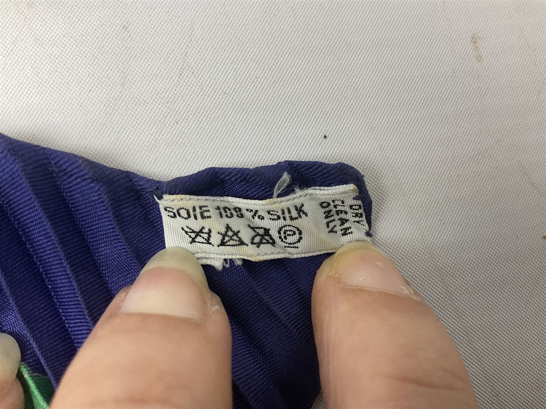 Hermès 'Les Folies Du Ciel' plisse silk scarf, designed by Loïc Dubigeon, printed with hot air balloon motifs, contained within twisted green rope border, on merging light and navy blue ground, with rolled hand stitched edges and Hermes material label, length 129cm