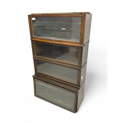 Globe Wernicke - early 20th century oak four-tier stacking library bookcase, four glazed sections enclosed by hinged and sliding doors