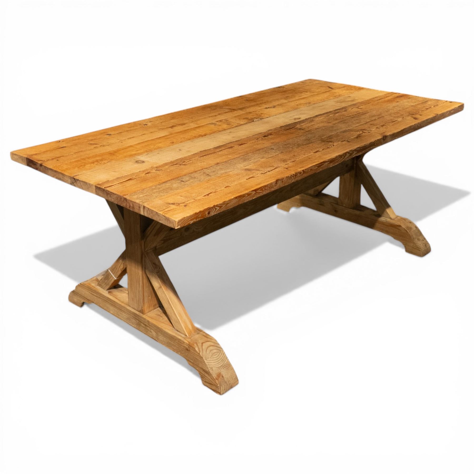 Pine country x-framed dining table, a rustic plank top raised on two x-framed supports