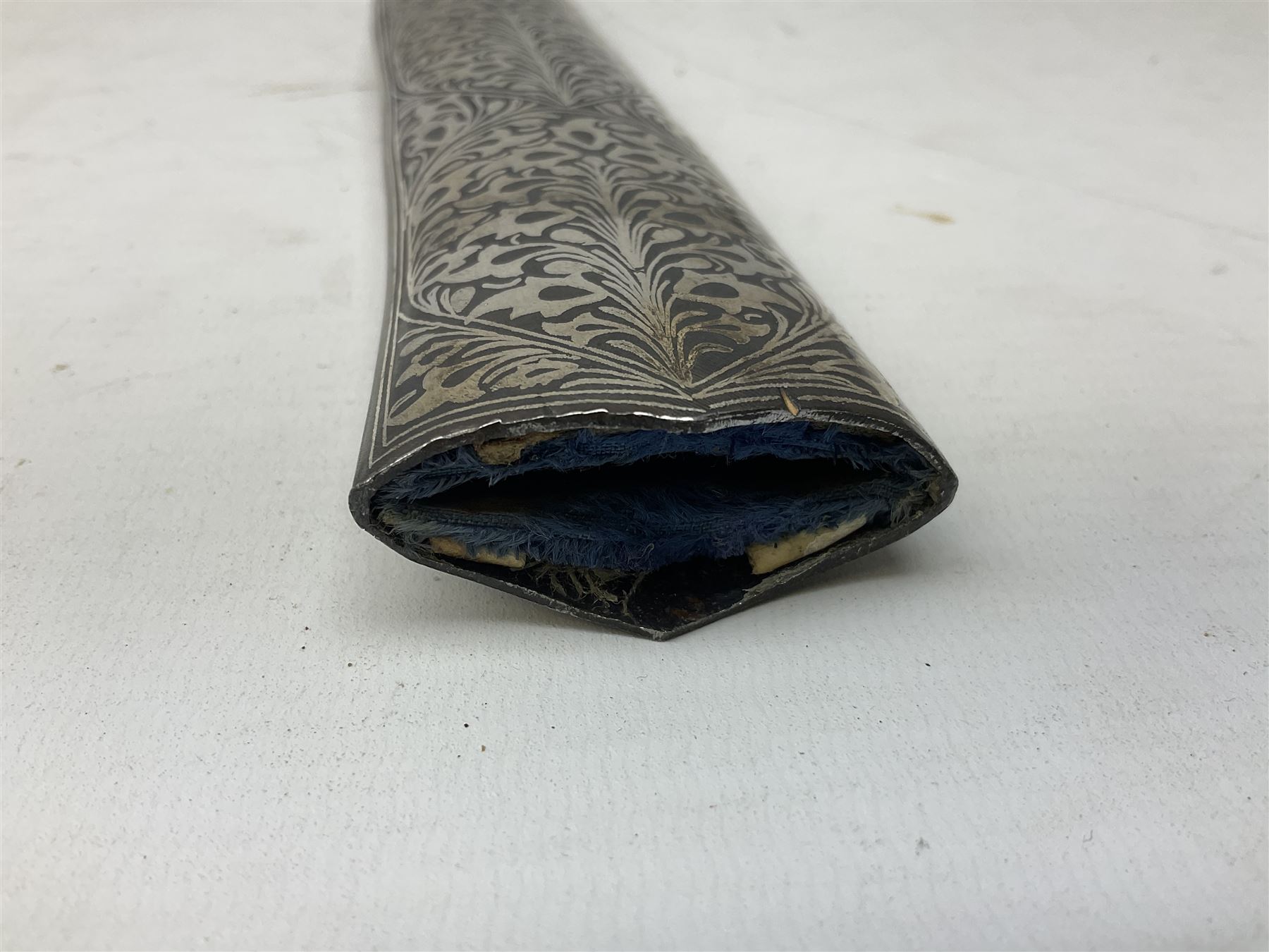 Indian Khanjar dagger with 28cm curving damascus steel blade inlaid with silver floral emblem, white metal and niello style grip in the form of a bird's head with pronounced beak and matching scabbard L44cm overall