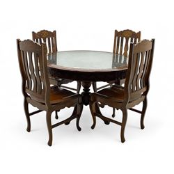 Pakistan carved hardwood brass inlaid circular dining table, and four rail back chairs with saddle seats