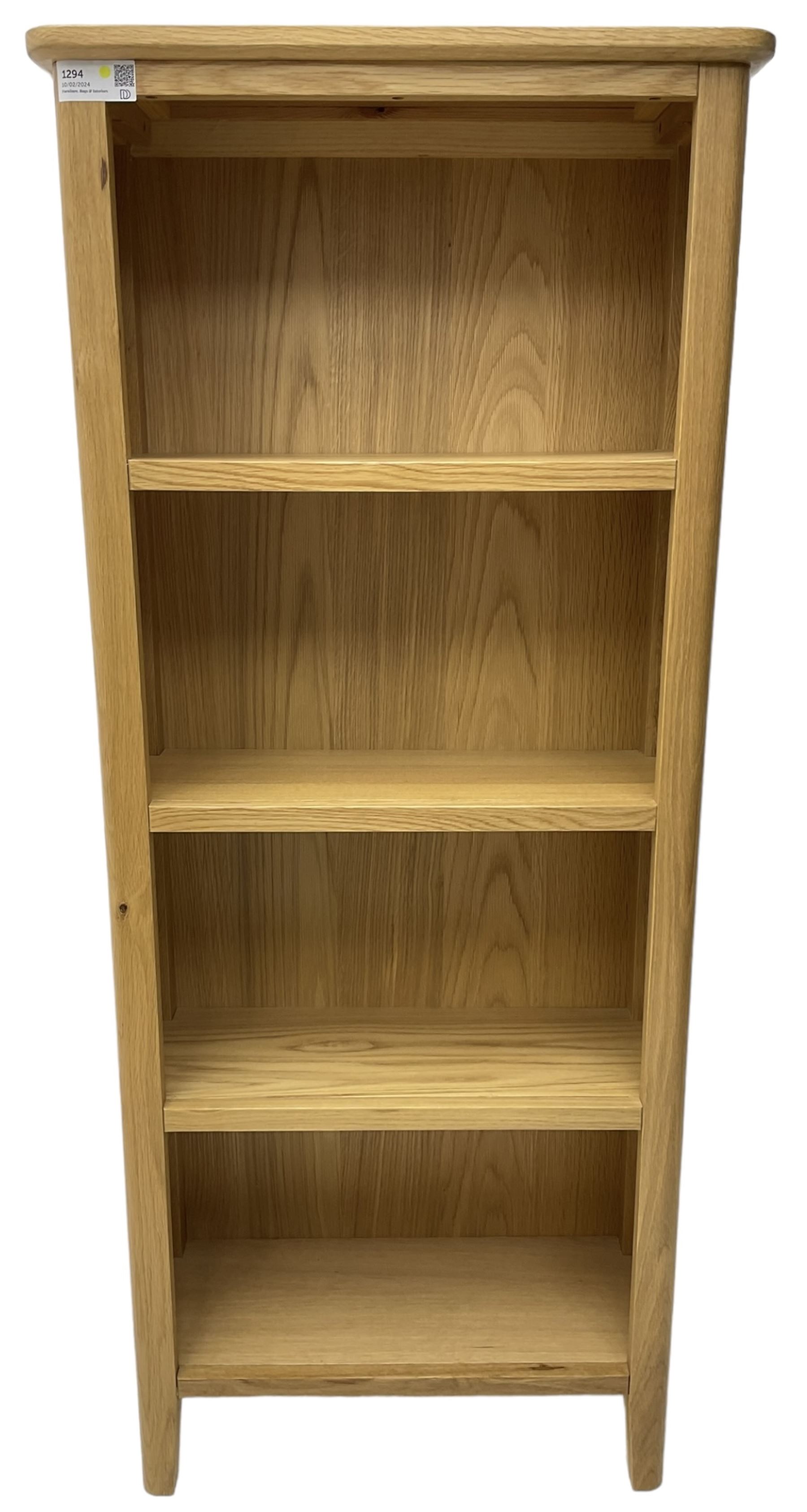 Contemporary light oak open bookcase, fitted with three shelves, on tapering supports
