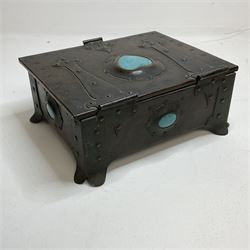 Arts and Crafts copper box, the lid decorated with stylised riveted hinges and inset with Ruskin type ceramic turquoise heart-shaped cabochon, the mount etched M.B 1913, and further cabochon roundel to each side panel, including one inset to the clasp acting as the knob to the locking mechanism, marked RS Douglas 1913 beneath, W16.5cm H7cm D15cm