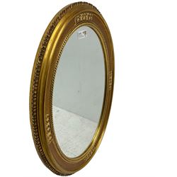 19th century design gilt framed oval wall mirror, shell moulded edge foliate decoration