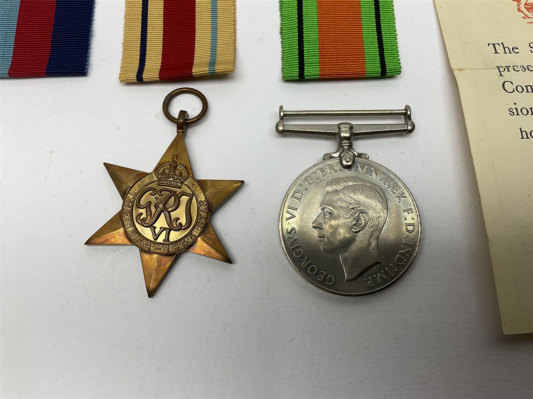 Twelve WW2 medals comprising four 1939-1945 war medals, four Defence medals, three 1939-1945 Stars and Africa Star; all with ribbons; some as groups in two issue boxes with slips