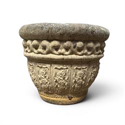 Set of three cast stone planters, circular form with C-scroll design frieze over a floral decorated body, weathered finish