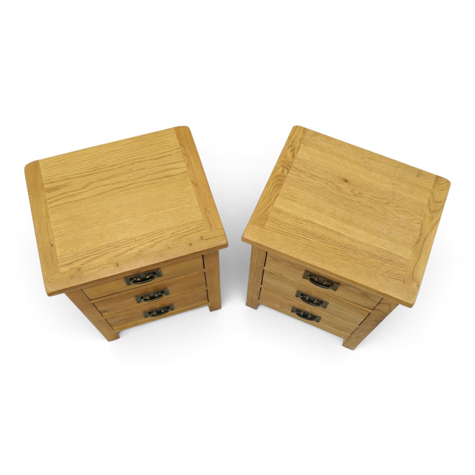 Pair of solid light oak bedside chests, rectangular top over three graduating drawers with metal handles and plates, on square feet
