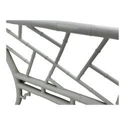 Late 20th century faux bamboo conservatory sofa, white painted frame with geometric openwork back and sides, loose cream cushions, on cylindrical supports (W134cm, D76cm, H80cm); matching armchair (W75cm, D76cm, H80cm); matching coffee table with glass insert (W46cm, D45cm, H36cm)