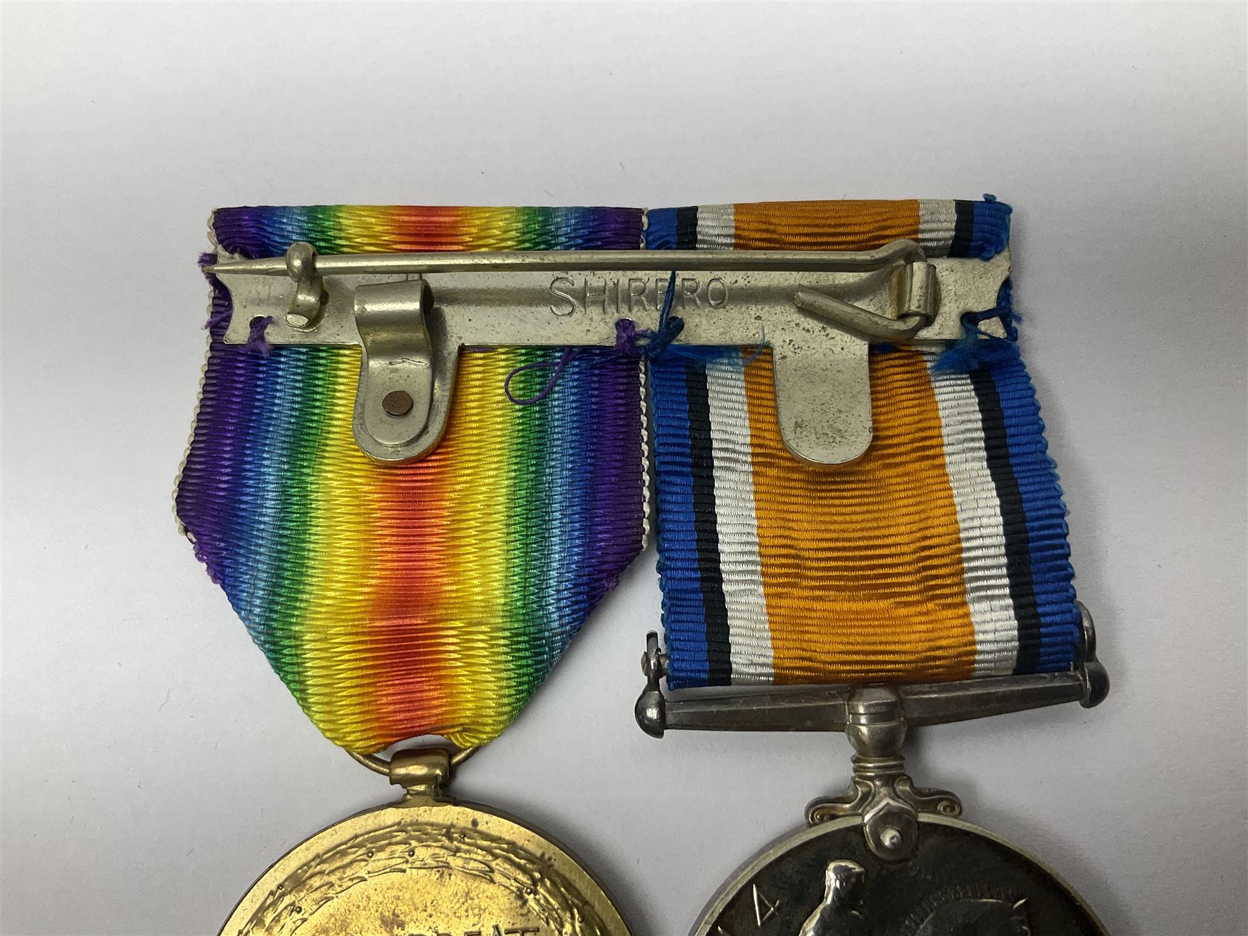 WWI pair of medals comprising British War Medal and Victory Medal awarded to G/62196 Pte. H. Ferguson R. Fus. with ribbons on wearing bar; together with bronze memorial plaque to Henry Ferguson (3)
