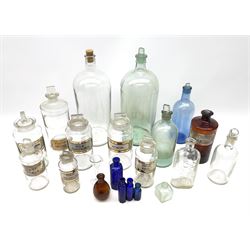A collection of apothecary bottles, to include 19th century and later examples, with inscribed gilt labels, largely clear glass examples, plus other Chemist bottles. 