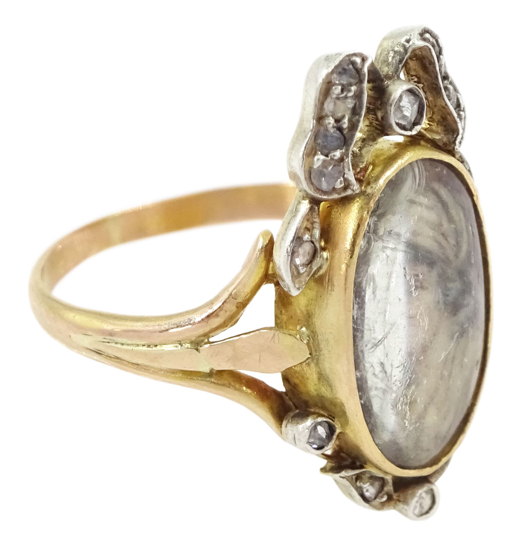19th century gold and silver diamond portrait ring, set with an oval miniature of a woman on ivory, under a glazed panel, with rose cut diamond bow and floral sprigs below, to trifuricated shoulders. This lot has been registered for sale under Section 10 of the APHA Ivory Act