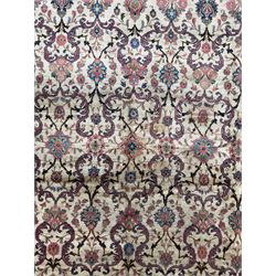 Northwestern Persian Meshkin hand-knotted carpet, the ivory field with an all-over design of scrolling vines and stylised floral sprays in burgundy, pink, and blue tones, enclosed by a raspberry red border of rosettes and palmettes linked by fine arabesques, from the region of Meshkin near Ardabil