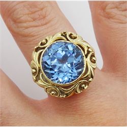 18ct gold single stone round synthetic blue spinel ring, with pierced leaf border