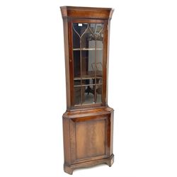 Late 20th century mahogany corner display cabinet, figured cavetto moulded and dentil cornice over astragal glazed door, figured panelled door with moulded frame, shaped apron and bracket feet