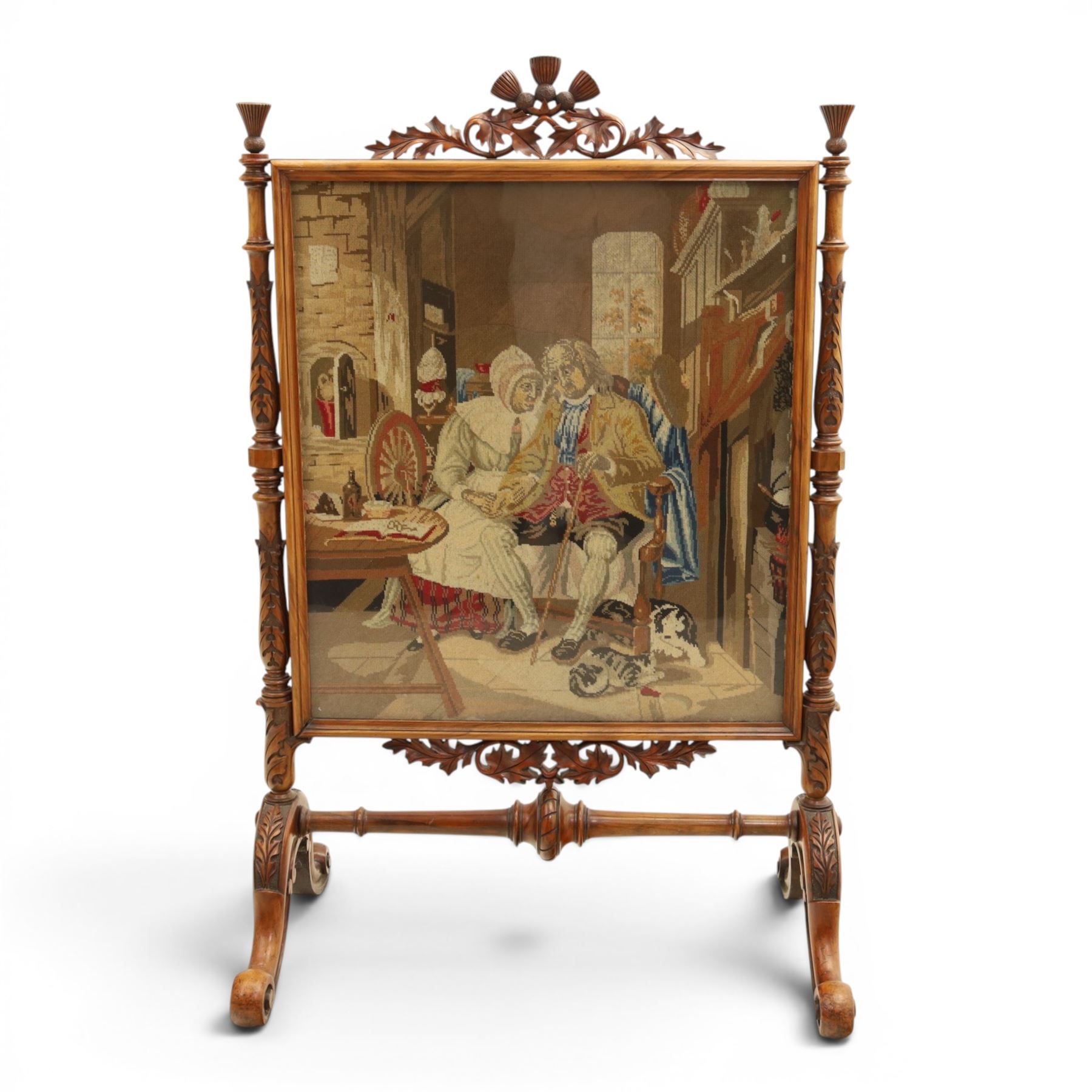 Two Victorian fire screens, comprising mahogany pole screen with glazed floral woolwork panel on turned support and triform base (H 142cm, W 48cm); and a larger carved walnut tapestry fire screen, glazed panel depicting a domestic interior scene, scroll carved cresting, barley twist uprights and turned stretcher base (H 75cm, W 49cm)