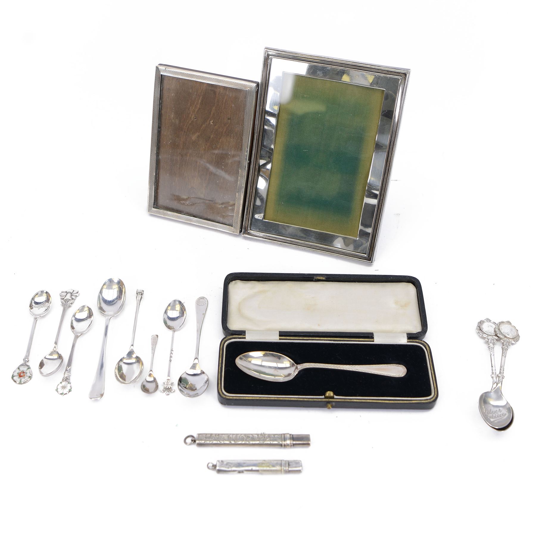 Group of silver, comprising two rectangular photograph frames, two pencil holders, boxed spoon and souvenir spoons, all hallmarked 