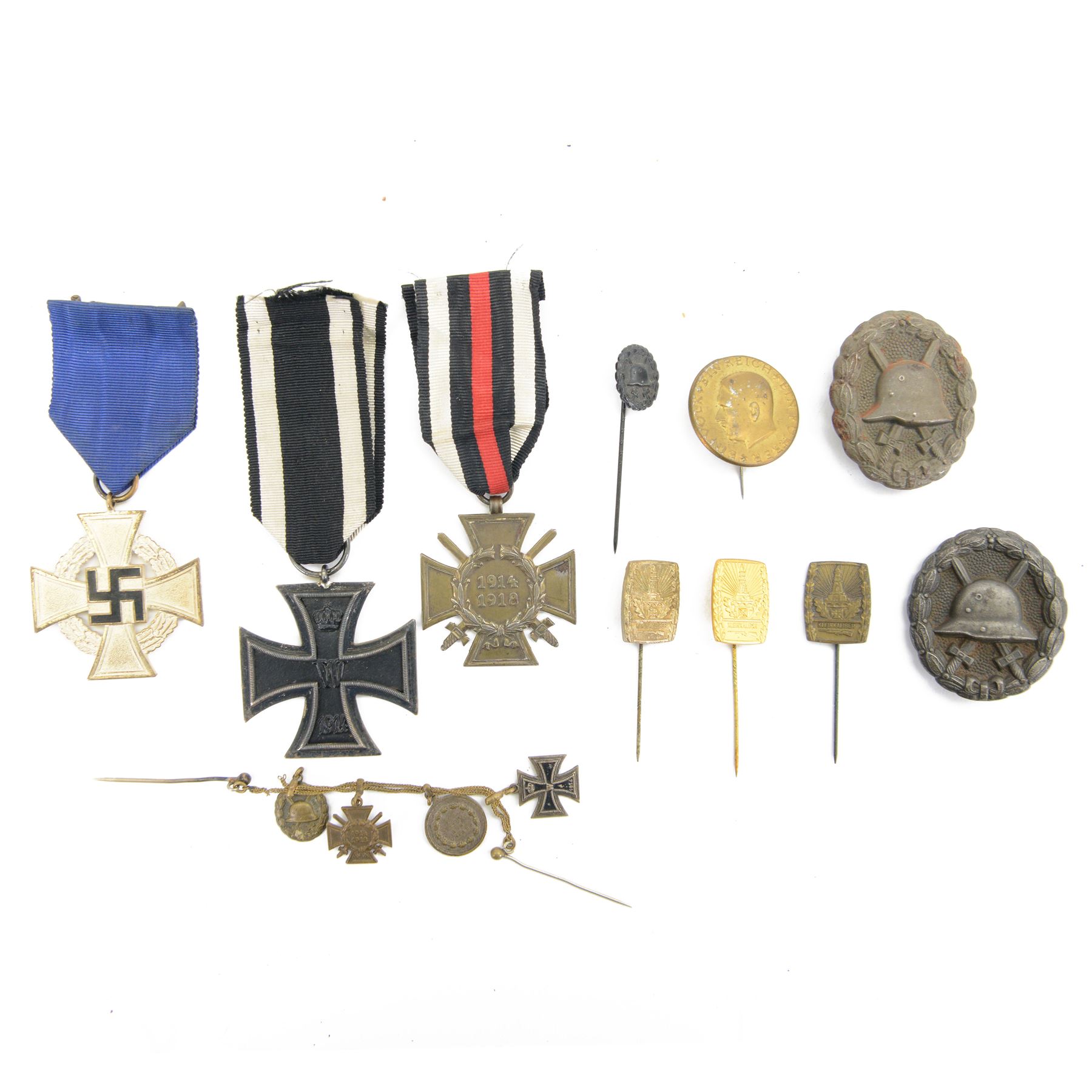WWII collection of German medals and badges, including Treue Dienst Ehrenzeichen, Honour Cross 1914-1918, two wound badges, miniature medal group upon a dress chain etc