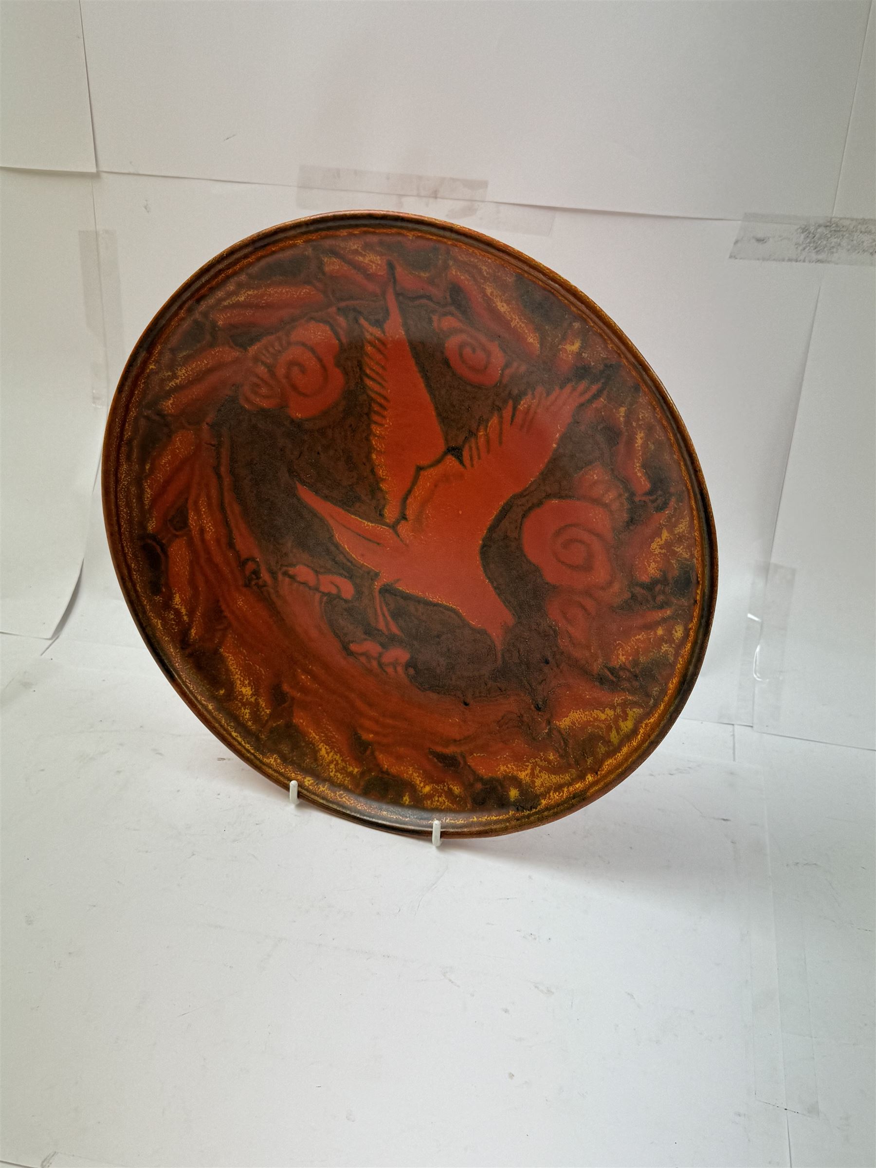 William Salter Mycock (1872-1950) for Pilkington's Royal Lancastrian, orange charger decorated with a bird in flight, D29cm
