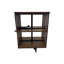 Edwardian oak revolving bookcase, moulded rectangular top over two tiers, fitted with hinged rest