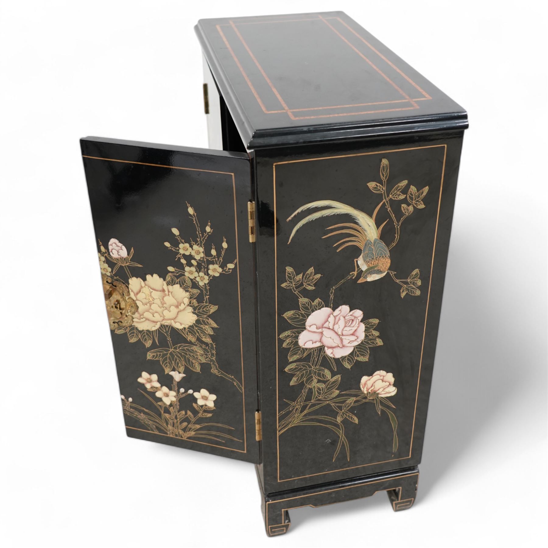 Chinese design black lacquered cupboard, decorated with birds and trailing flowers (W61cm, H81cm, D31cm); together with a similar Chinese design three drawer chest (W57cm, D34cm, H61cm)