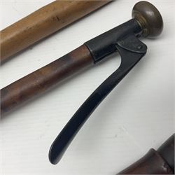 Two late 19th century fruit picker canes, the first example a French ebonised bamboo cane, with pair of fruit scissors to base, the handle stamped Cueille Fruit, the second example with grabbing action, the cap stamped A C Harris, Leicester, together with two other 19th century canes, one with fork and the other with hoe