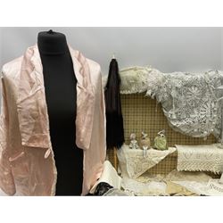 Collection of Victorian and later lace, to include a lace bonnet with floral detail, doilies, a selection of lace collars and cuffs, together with a black silk parasol, three porcelain pin cushion dolls, a suitcase, etc