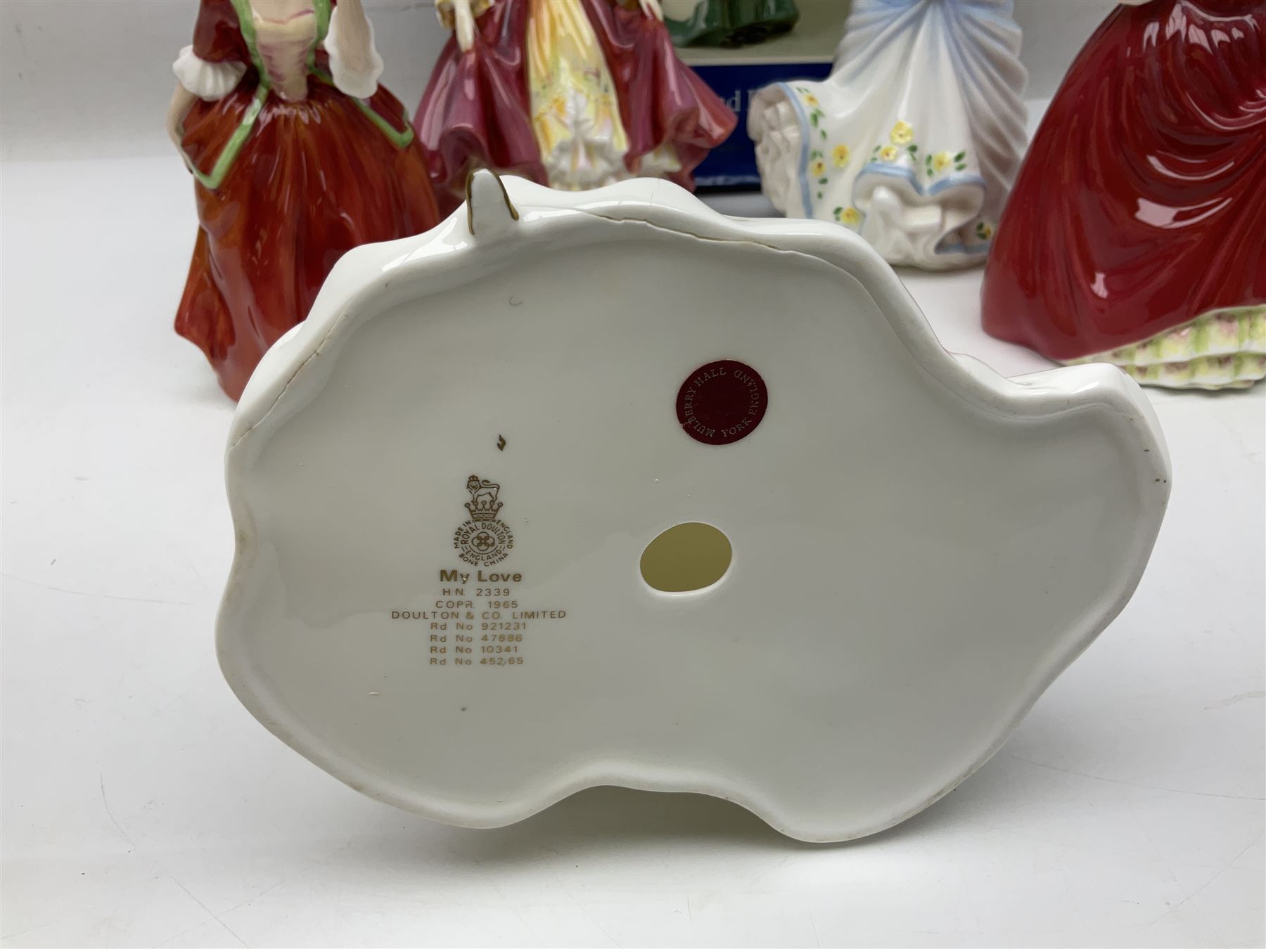 Five Royal Doulton figures, comprising Flower of Love HN3970, Emily HN3688, Southern Belle HN2229, Helen HN3886 and My Love HN2339, all with printed mark beneath, some with boxes, together with a Royal Doulton Figures reference book by D Eyles and R Dennis