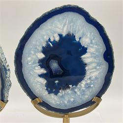 Pair of blue agate slices, polished with rough edges raised upon gilt metal stands, H22cm