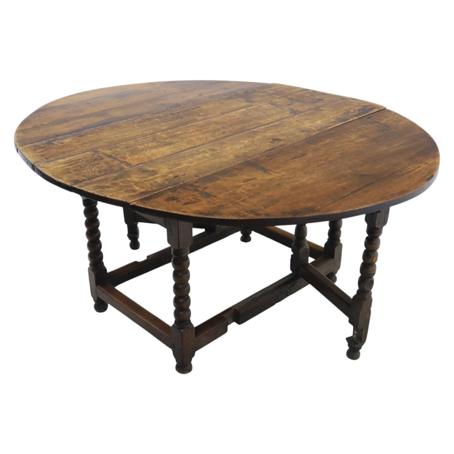 18th century country oak oval dining table, plank top with two drop leaves and gate-leg action, single drawer, raised on bobbin turned legs