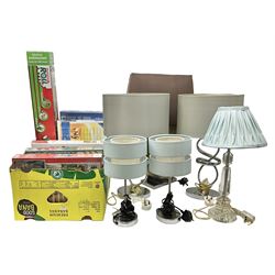 Quantity of jigsaw puzzles, mostly in original packaging, together with a puzzle and roll jigsaw board and six table lamps with fabric shades, in two boxes