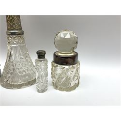 Early 20th Century glass scent bottle with silver collar, hallmarked G E Walton & Co Ltd 1912,  another glass bottle with silver collar stamped Birmingham, hallmarks worn and indistinct, cylindrical scent bottle with silver screw thread cap, two silver napkin rings stamped Birmingham 1962 and 1922, and another napkin ring