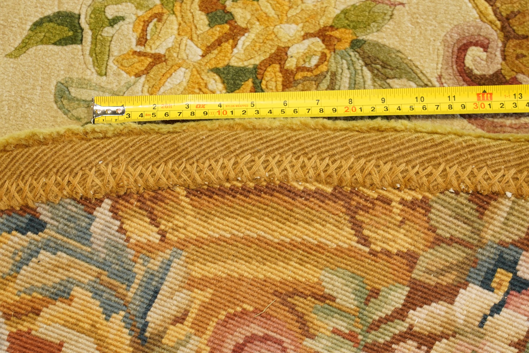 20th century French Aubusson style circular carpet, cream ground of Savonnerie design with scrolling floral and scallop motifs