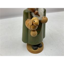 German Erzgebirgische Volkskunst folk art carved and stained wood smoking men incense burner figure, modelled smoking a pipe, with sticker label beneath, H19cm