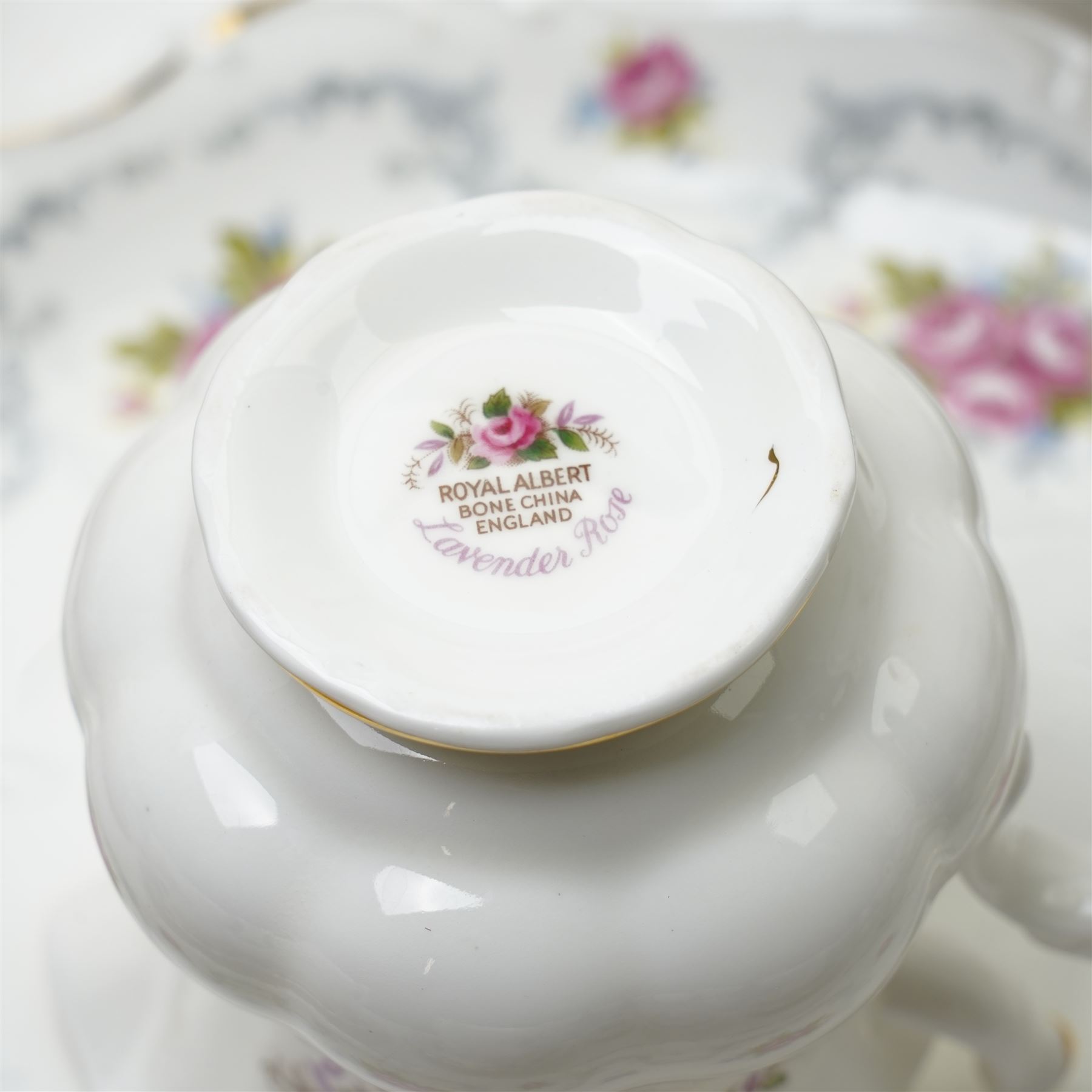 Royal Albert Lavender Rose tea and dinner wares, comprising eight dinner plates, and eight small dinner plates, eight side plates, open serving dish, teapot, open sucrier, salt and pepper, sandwich plate, sauce boat and saucer, eight teacups and saucers, six bowls, six oval serving dishes, and one platter