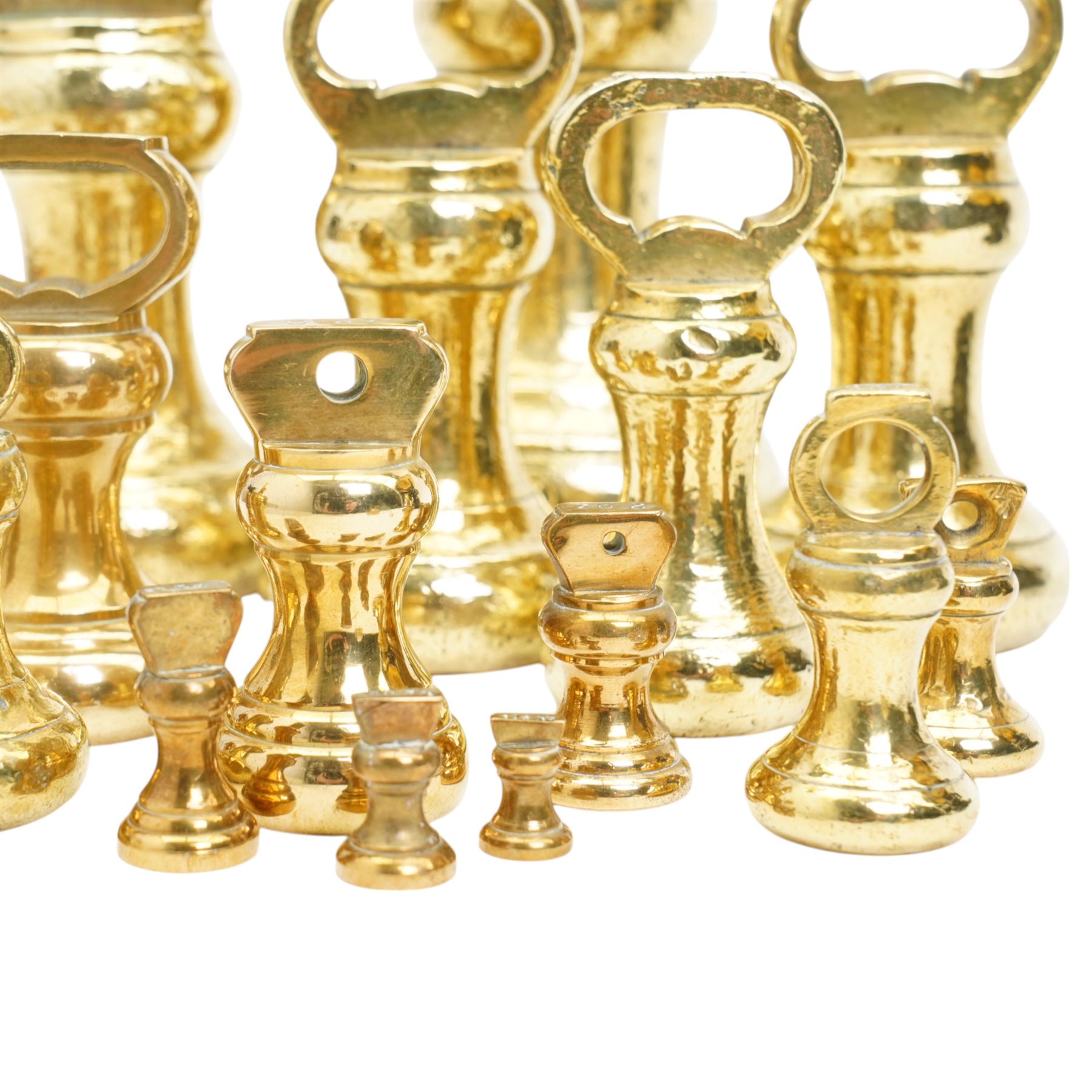 Group of fifteen brass bell weights 1/4oz-7ibs mostly Victorian, some marked with a sheep in a sling, possibly the mark for Holmfirth and a set of Libra scales with a set of graduated brass flat weights