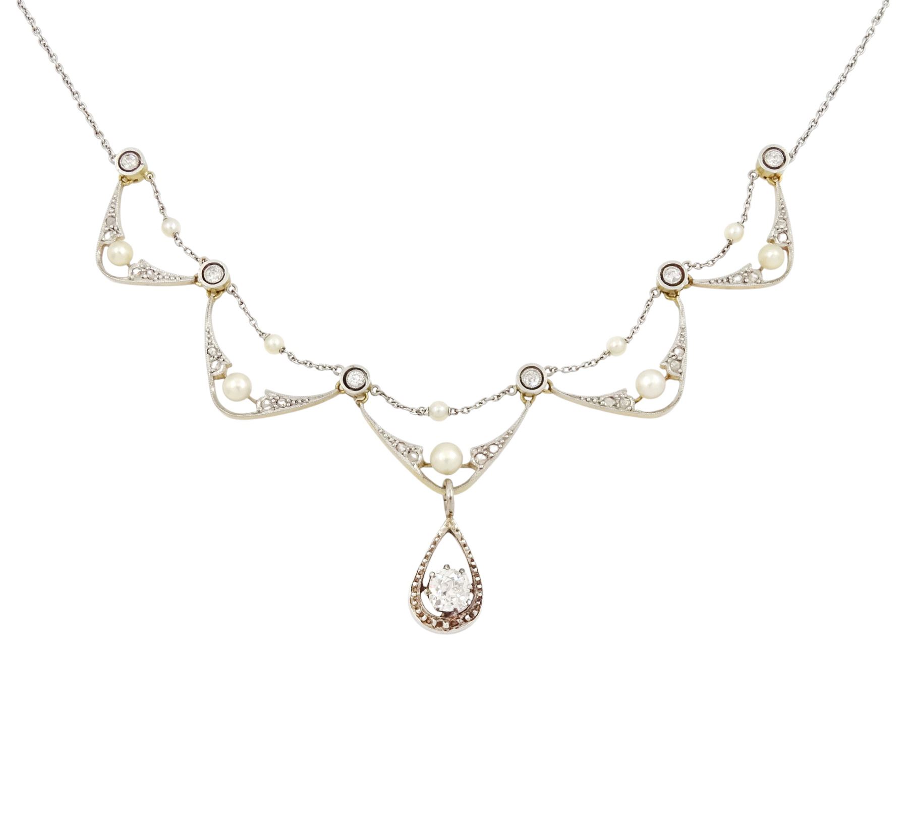 Early 20th century 18ct gold and platinum diamond and pearl necklace, five central fancy swag links, milgrain set with rose cut diamonds and a single pearl, with a trace link pearl top, each spaced by an old cut diamond, the central link suspending an old cut diamond of approx 0.55 carat, to a platinum trace link chain necklace, total diamond weight approx 0.75 carat