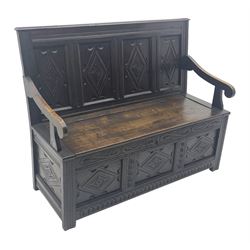 17th century and later box settle, the quadruple panelled back carved with lozenges above hinged seat, panelled front with scroll carved cresting rail and guilloche carved uprights, moulded stile supports joined by arcade carved rail 