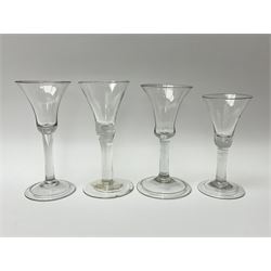 Four 18th century drinking glasses, with bell shaped bowls, three examples with folded foot. 