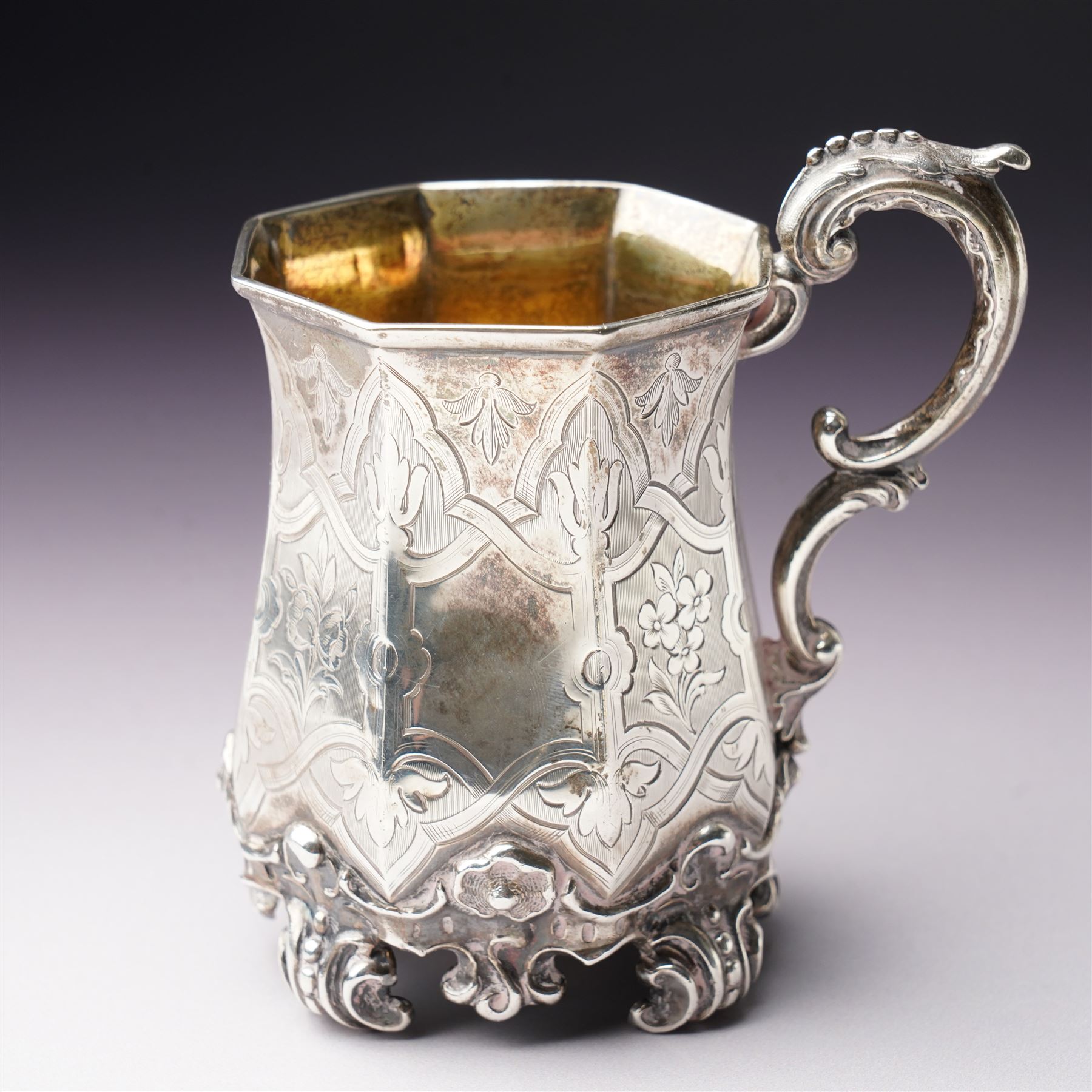 Victorian silver christening mug of panel sided design with gilded interior, engraved decoration and scroll handle and feet H10cm London 1848 Maker Charles Reily & George Storer