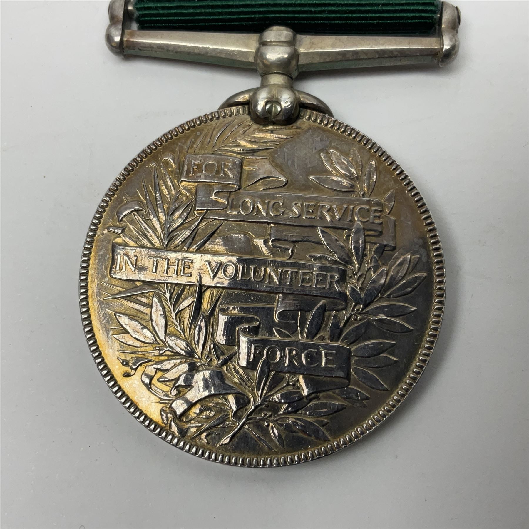 Victoria Long Service in the Volunteer Force Medal awarded to 369 Bombr. W. Woodward 1st Lincs. V.A.; and reproduction Victoria India Medal with Lucknow clasp; both with ribbons (2)