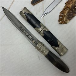 Eastern dagger with 14.5cm ornate fullered blade and nickel mounted horn grip; in nickel mounted ebonised wooden scabbard L25,5cm overall; another smaller Eastern dagger with animal head pommel and nickel mounted leather scabbard; three small sheathe knives with simulated antler grips; letter opener in the form of a German hunting knife with hoof grip; and Japanese wooden Floating Fish Knife with stainless steel blade (7)